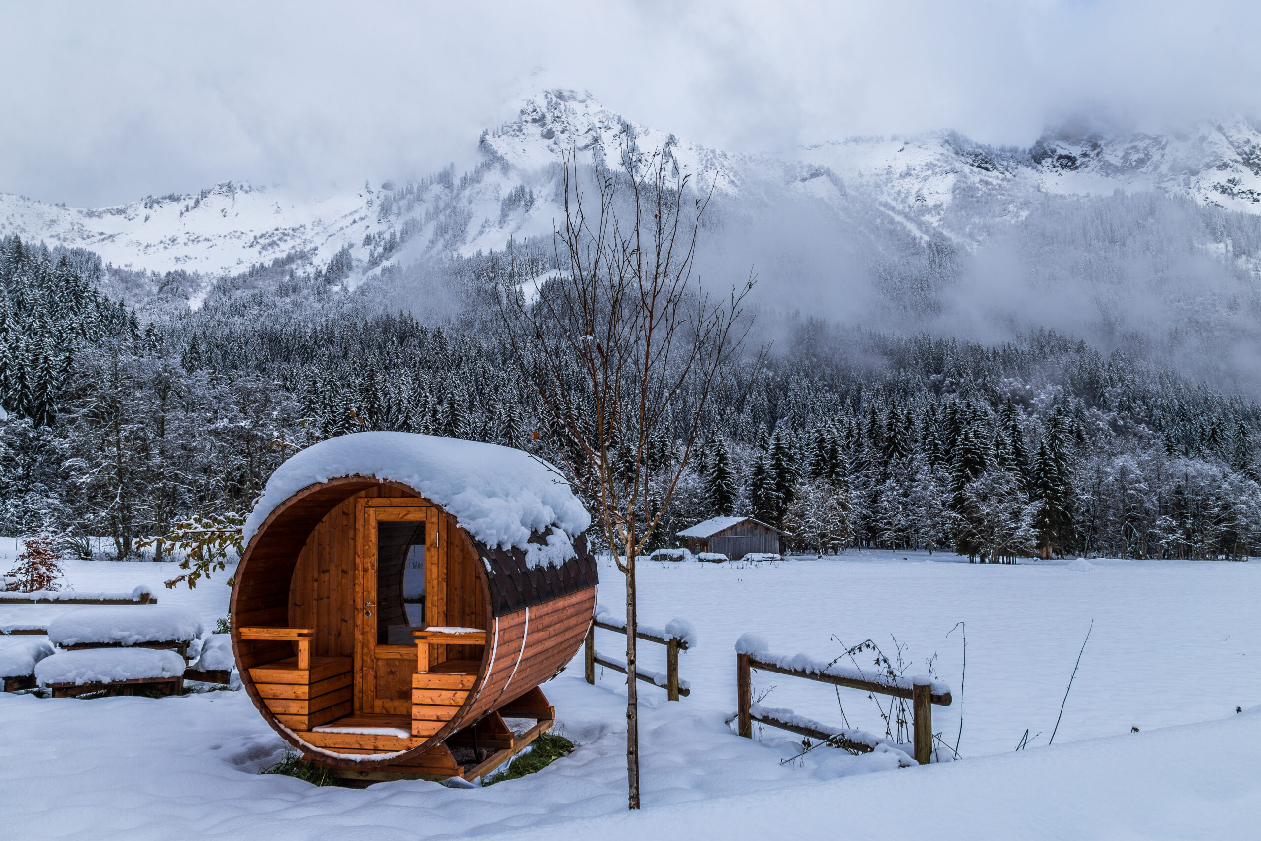 Outdoor Barrel Sauna in a snowy landscape