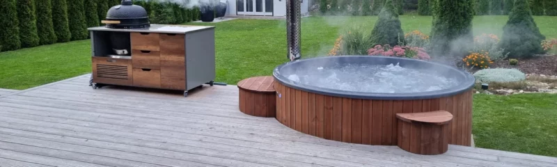Neptune Hot Tub health benefits article - wood fired hot tub sunken into customers decking with matching bbq